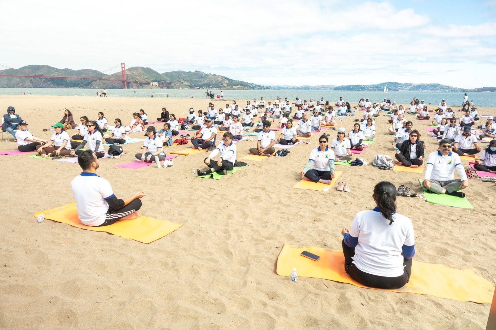 Where the Pacific meets the pose — Yoga at the Golden Gate.  On June 20, 2026, @CGISFO marked the 12th #InternationalDayofYoga2026 at Crissy Field East Beach, San Francisco, against the magnificent backdrop of the iconic Golden Gate Bridge emerging through the morning fog.