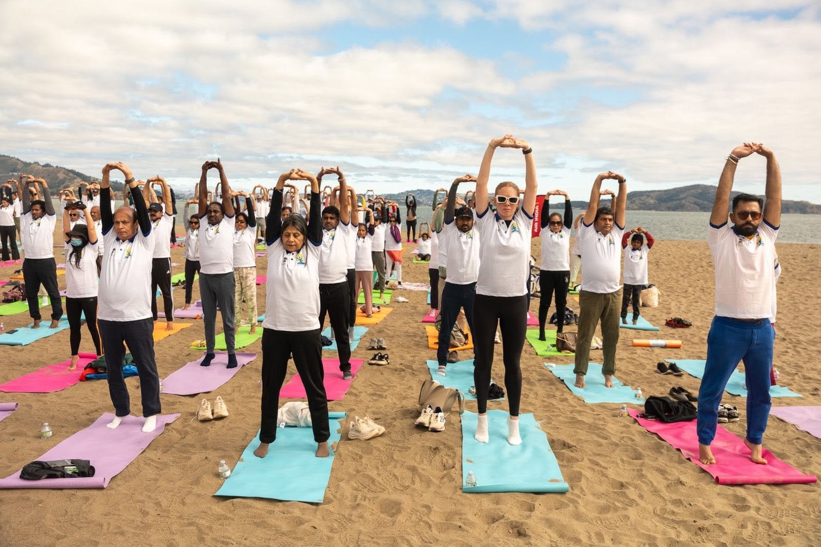 Where the Pacific meets the pose — Yoga at the Golden Gate.  On June 20, 2026, @CGISFO marked the 12th #InternationalDayofYoga2026 at Crissy Field East Beach, San Francisco, against the magnificent backdrop of the iconic Golden Gate Bridge emerging through the morning fog.