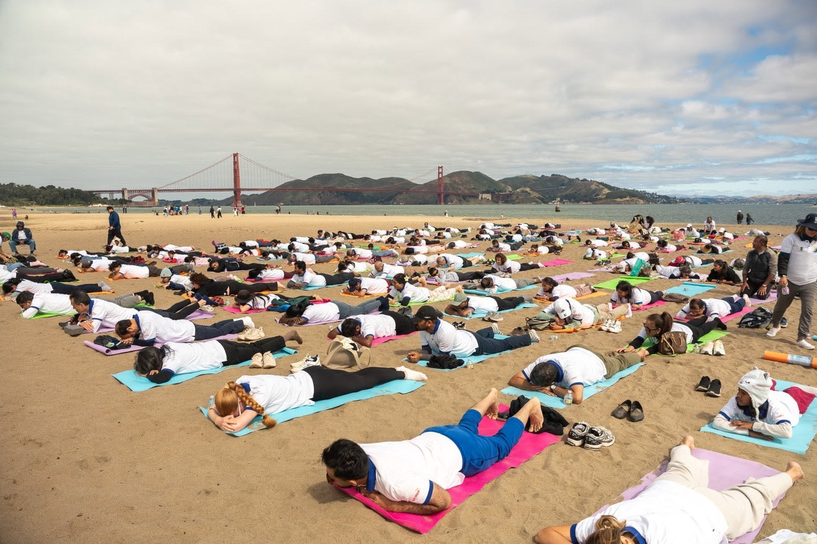 Where the Pacific meets the pose — Yoga at the Golden Gate.  On June 20, 2026, @CGISFO marked the 12th #InternationalDayofYoga2026 at Crissy Field East Beach, San Francisco, against the magnificent backdrop of the iconic Golden Gate Bridge emerging through the morning fog.