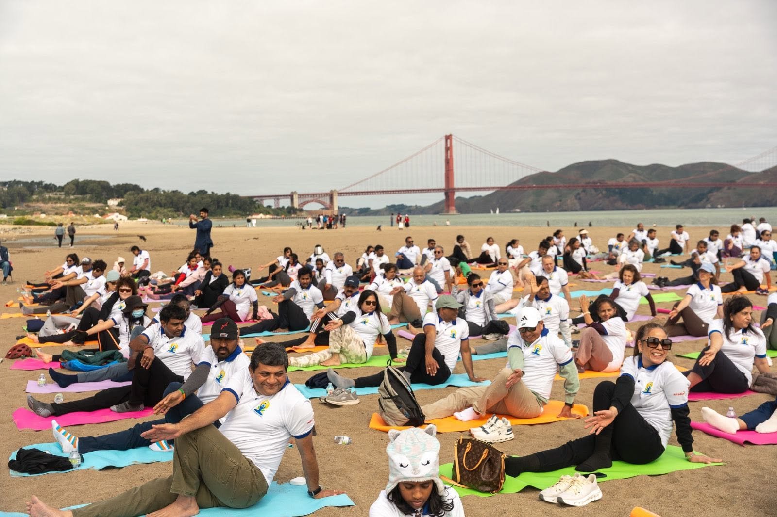 Where the Pacific meets the pose — Yoga at the Golden Gate.  On June 20, 2026, @CGISFO marked the 12th #InternationalDayofYoga2026 at Crissy Field East Beach, San Francisco, against the magnificent backdrop of the iconic Golden Gate Bridge emerging through the morning fog.
