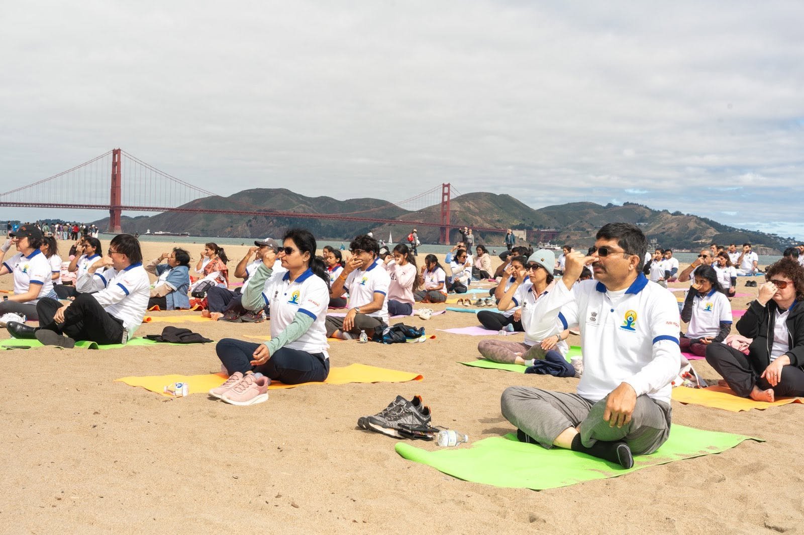 Where the Pacific meets the pose — Yoga at the Golden Gate.  On June 20, 2026, @CGISFO marked the 12th #InternationalDayofYoga2026 at Crissy Field East Beach, San Francisco, against the magnificent backdrop of the iconic Golden Gate Bridge emerging through the morning fog.