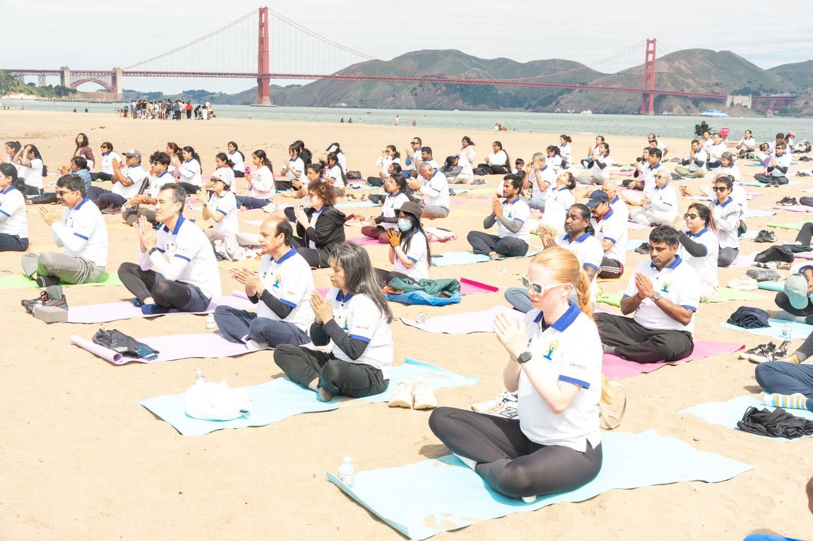 Where the Pacific meets the pose — Yoga at the Golden Gate.  On June 20, 2026, @CGISFO marked the 12th #InternationalDayofYoga2026 at Crissy Field East Beach, San Francisco, against the magnificent backdrop of the iconic Golden Gate Bridge emerging through the morning fog.